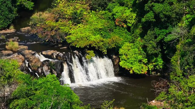 Close up shot of Kote Abbey Waterfalls with trees and rocks at day time, static shot, drone shot, 4k.