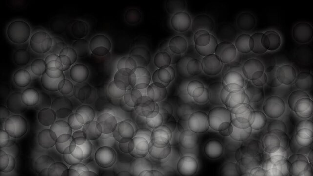 Glowing spherical objects gently falling downward creating smooth cinematic dreamy abstract motion background loop
