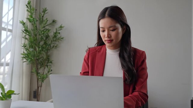 Professional asian businesswoman opening and working on laptop computer at office