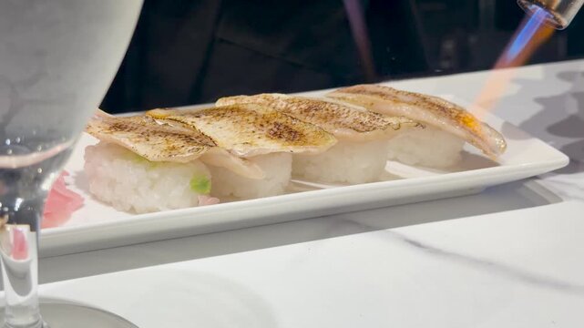 Chef Searing Nigiri Sushi with a Blowtorch Flame in Kanazawa Japan