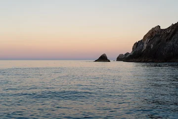 Fototapeten Küste Calm sea and rocky coast at sunset. Horizontal.  © Uri Prat