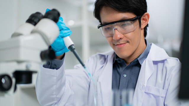 Scientist,Beautiful young woman scientist in laboratory working.female scientist doing some research.report and writing medical results,medicine documents in laboratory for healthcare,science review