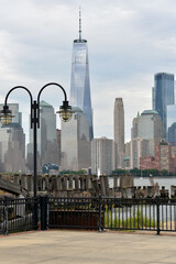 Obraz premium Traditional Lamps And Intricate Ironwork Contrast With Modern Glass Skyscrapers new york
