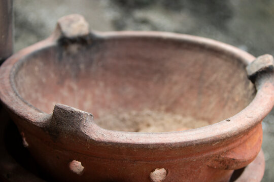Old clay pot for cooking in the kitchen, closeup of photo