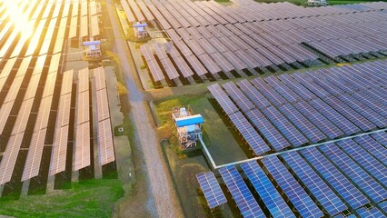 Obraz premium Sunlit aerial scene of solar panels stretching across the land, showcasing eco-innovation, clean energy generation, sustainability, technological growth, efficiency, resilience, low-carbon solutions. 