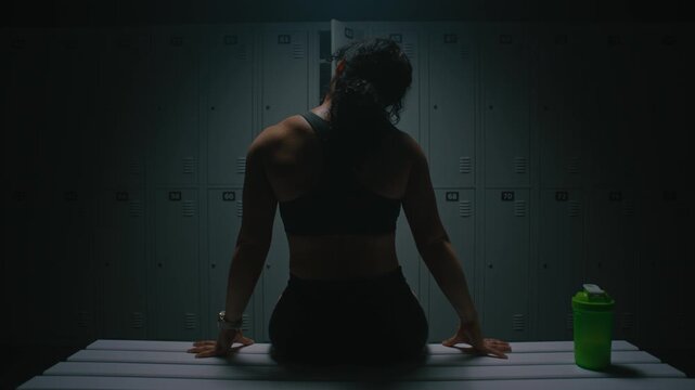 Fit Female Athlete on Bench, Performing Neck and Arm Stretches. Woman Muscular Back and Shoulder Definition. Post Workout Routine, Importance of Recovery and Cooling Down After Physical Exertion.