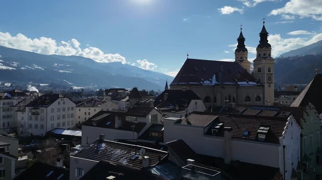 Ascending Drone Flight Revealing Cathedral, Bressanone Town and Alps Under Clear Sky, South Tyrol, Italy
