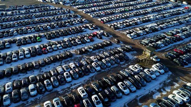 Drone view of automotive logistics and vehicle storage on a snowy ground, UK.
