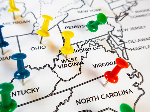Macro close-up of an Eastern US map with colorful push pins marking North Carolina, West Virginia, Ohio, and Kentucky. Ideal for regional logistics, business tracking, demographics and travel planning