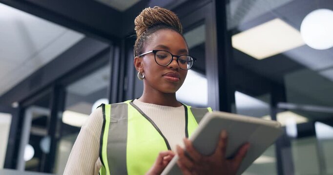 Construction, office and black woman on tablet for online report, building assessment and review. Supervisor, low angle and person on tech for compliance, renovation project and property evaluation
