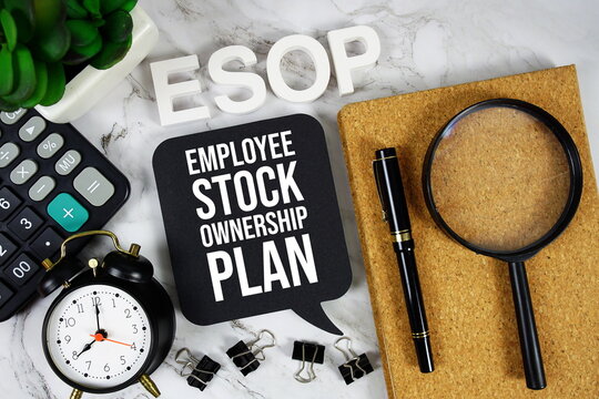 ESOP - Employee Stock Option Plan acronym with calculator, alarm clock and magnifying glass, Business and Financial concept background