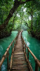 Fototapeta premium A narrow bamboo bridge crosses turquoise water, surrounded by lush green tropical foliage and dense trees, creating a serene jungle pathway.