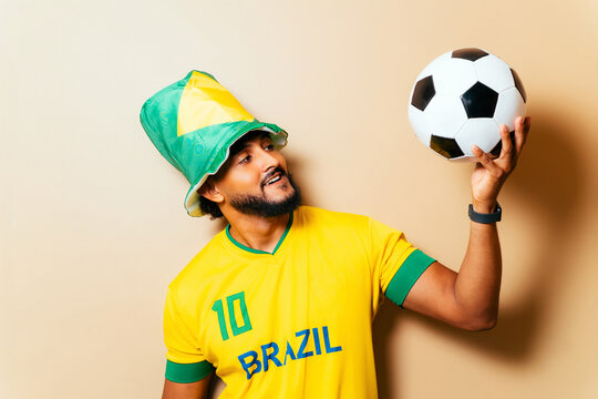 Brazil soccer fan celebrating victory holding ball