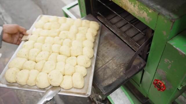 Checking Freshly Baked Moringa Pandesal Inside Street Oven During Baking Process
