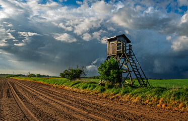  hunting tower in a field during a spring storm