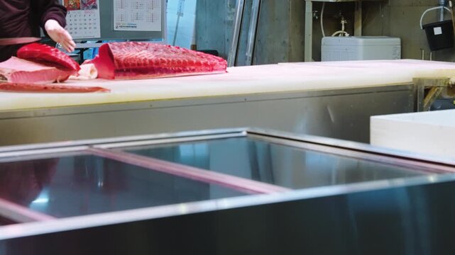 Huge piece of Pacific Bluefin Tuna being sliced in Sashimi in Japanese Fish Market