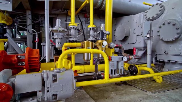 Complex system of pipes, pumps and valves at an industrial compressor station in a factory