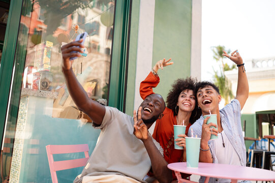 A group of multicultural university friends enjoys online shopping and fun moments together
