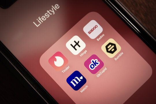 Quito, ECUADOR - Oct 13 2025 : Close-up smartphone screen showing popular dating apps (Tinder, Hinge, Badoo, Match.com, OkCupid, Bamble) in a lifestyle folder.