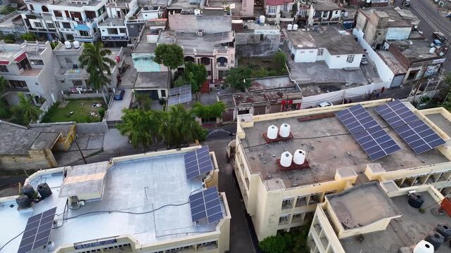 Aerial view of rooftop solar panels on residential homes in India.