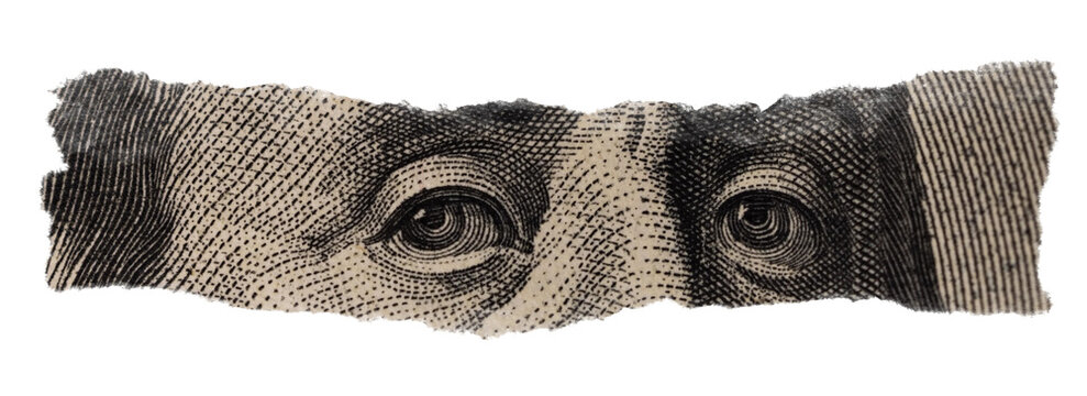 Close-up of Benjamin Franklin's Eyes on Torn Dollar Bill
