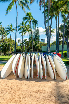 Row of white surfboards standing in the sand in Waikiki, Hawaii