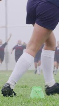 Rugby ball, foot and person on field with kick, start game or winter match in competition. Sport, player and football on tee for challenge, score conversion or accuracy practice with fitness on grass