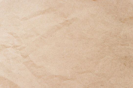 Vintage brown paper texture background with soft crumpled creased pattern and organic fiber details for retro message mockup