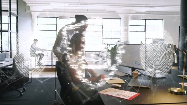 Standing man leaning pointing tab urging woman reading IT graphs verifying data print shield rising