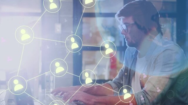 Man typing at laptop in office, initiating expanding user-network overlaying tech while fixing data