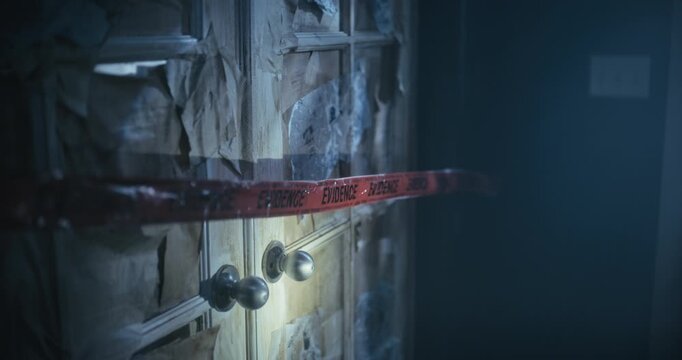 Woman with flashlight removing red evidence tape and entering scary, dark room - steady cam shot
