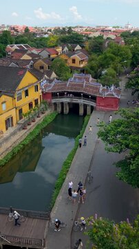 Aerial view of Chua Cau or Japanese Covered ancient Bridge and River in Old city of Hoi An, Vietnam. One of the most travel popular touristic destinations, UNESCO world heritage 