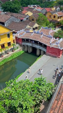 Aerial view of Chua Cau or Japanese Covered ancient Bridge and River in Old city of Hoi An, Vietnam. One of the most travel popular touristic destinations, UNESCO world heritage 