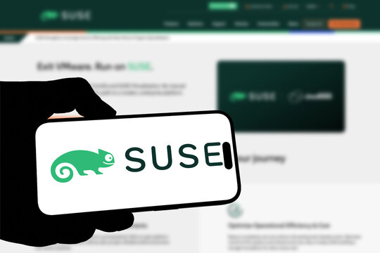 Kiel, Germany - 05-20-2026: Smartphone displaying the German enterprise software company SUSE app in the App Store in a workspace environment with laptop and notebook