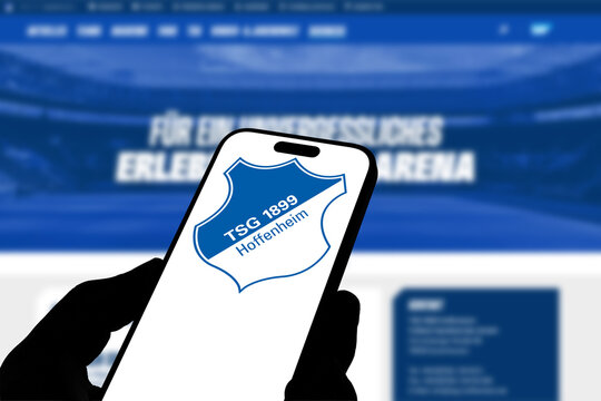 Kiel, Germany - 05-20-2026: Smartphone displaying the German football club TSG Hoffenheim app in the App Store in a workspace environment with laptop and notebook