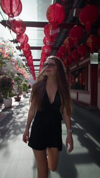 Tourist woman strolling through Chinatown Singapore surrounded by traditional architecture vibrant streets and famous travel attractions in Asia