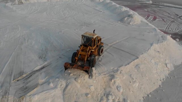 Front loader moves salt across white flat with machinery in background under bright sky forming dynamic industrial harvesting action perfect for resource production and arid landscape stock video