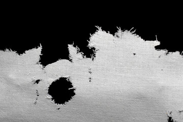 a torn old white rag, canvas with holes and fraying edges © Remigiusz Góra