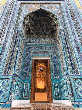 Ornate tilework portal mausoleum at Shah-i-Zinda necropolis in Samarkand with turquoise mosaics and muqarnas vaulting. Ideal for travel publications and cultural heritage projects.