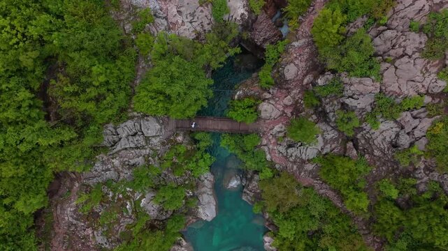 Man crossing a bridge top down view by drone in Theth Albania