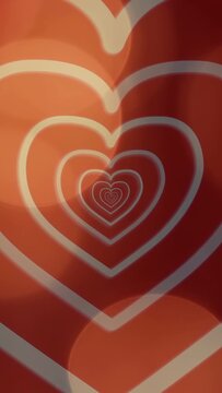 Vertical video: On loop start nested hearts pulsing inward while bokeh drifting, forming loop panel