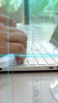 Vertical video: Man typing on laptop keys right hand pressing initiating overlays for coding review