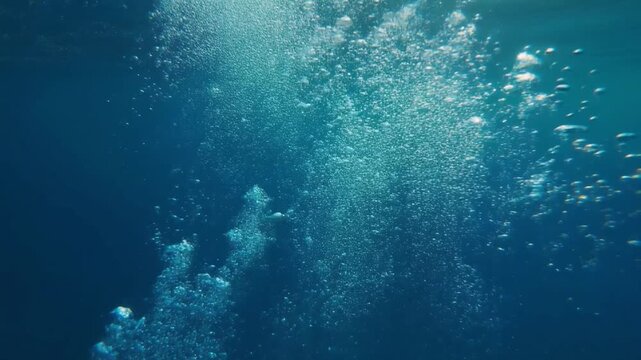 Bubbling underwater world with light rays illuminating the ascending air pockets creating a mesmerizing and serene aquatic ambiance