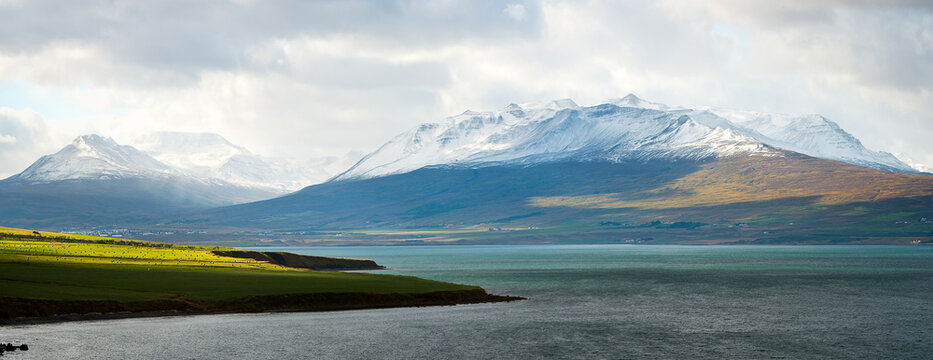 Snow capped mountains lakes and green pastures of Iceland