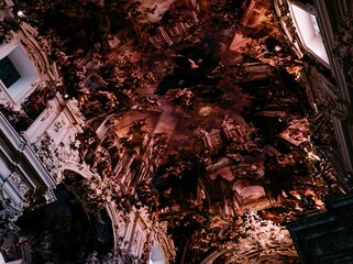Obraz premium Elaborate painted ceiling fresco adorns a historic church interior for religious education, architectural history and museum promotional materials