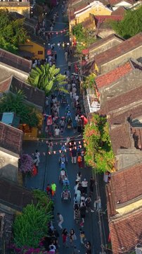 Aerial panoramic view of Hoi An city, Da Nang province, Vietnam. Pedicabs carrying tourists for sightseeing in the old town, UNESCO world heritage. One of the most travel popular touristic destination