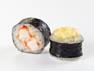 Two maki sushi rolls, one with shrimp filling and one baked with a cheese cap, isolated on a white background. © Andrei Starostin