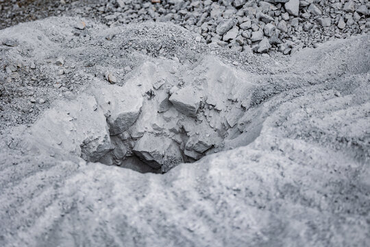 Technological hole in rock of quarry for placing explosives . Carrying out blasting operations in open pit mine ore