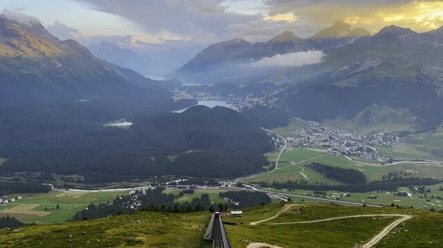 Beautiful Panoramic View over Mountain Train and with Five Alpine Lakes and Mountainscape in the Swiss Alps in Sunset and City of St Moritz, Engadin, Maloja, Grisons, Switzerland.