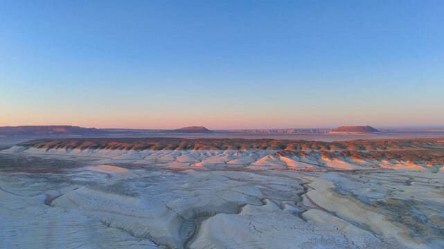 The gentle light of dawn in the Mangistau desert with a view of Mount Bokty